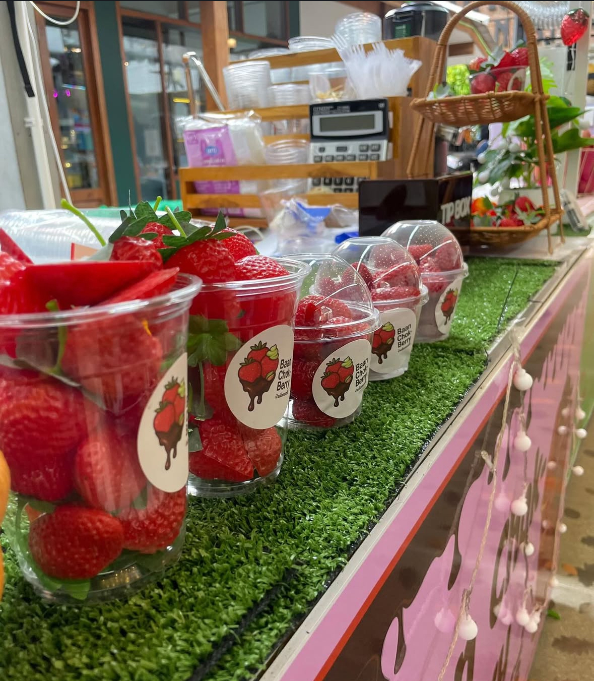 Fresh strawberry cups ready at counter